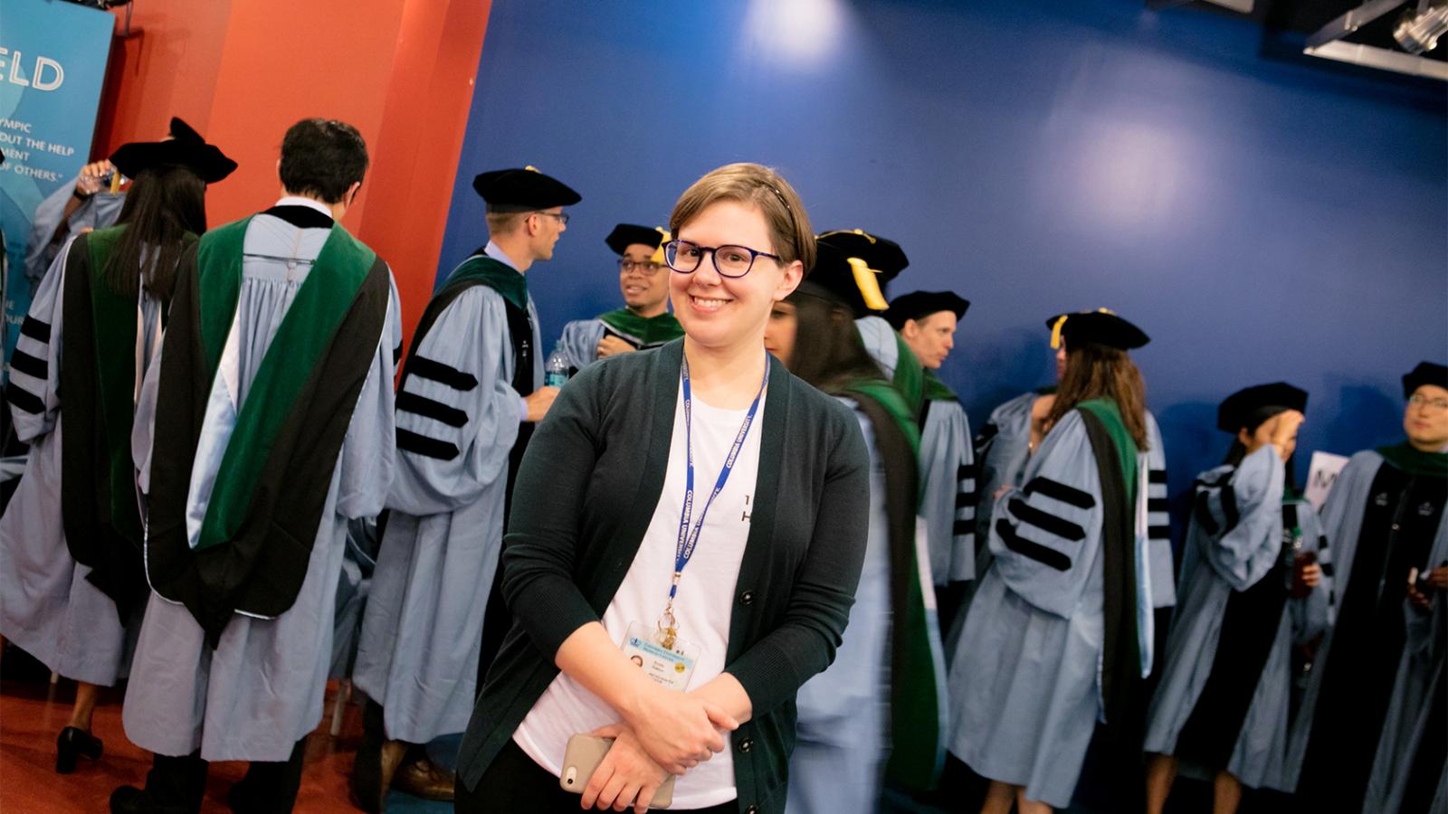 Commencement volunteer with graduate line-up