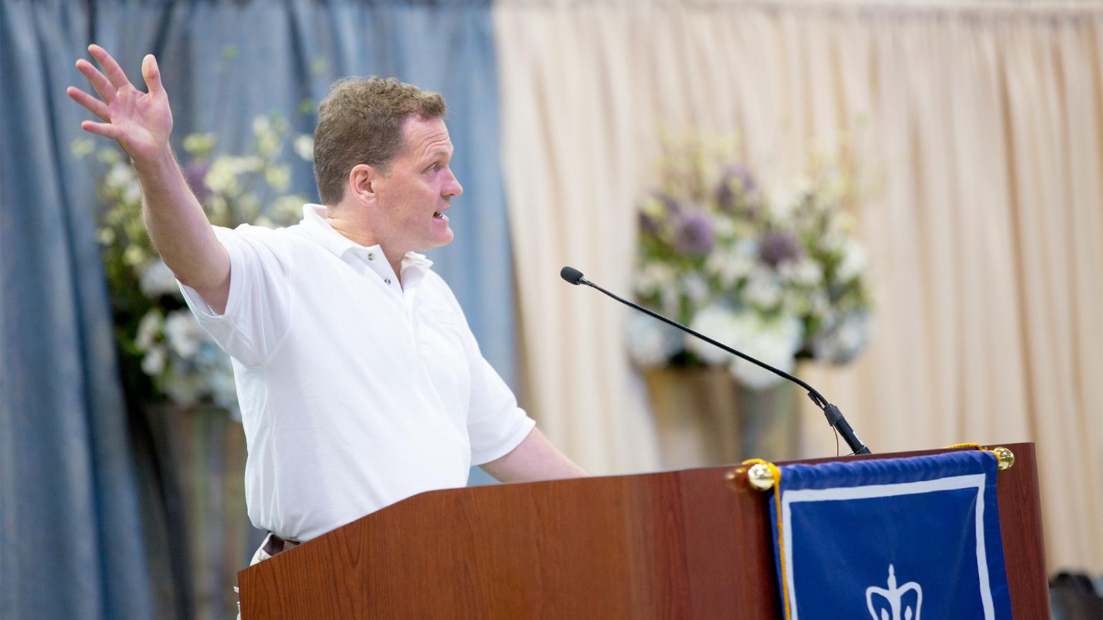 Commencement volunteer giving fire safety announcement at podium