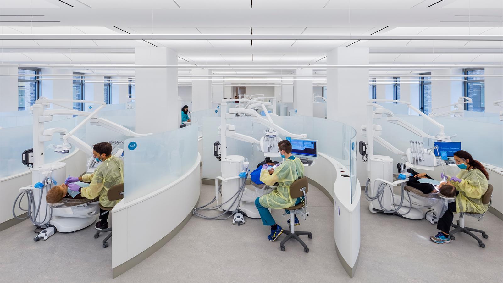 Operatories with dental clinic students and patients