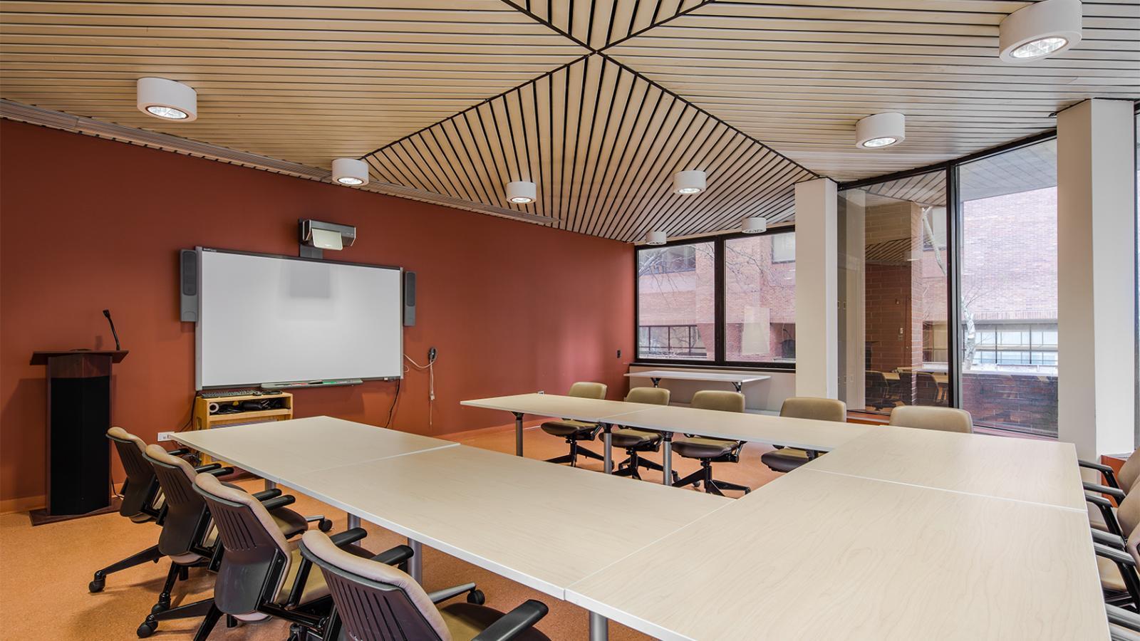 Conference Room 103A with U-shaped long table, chairs, and large windows