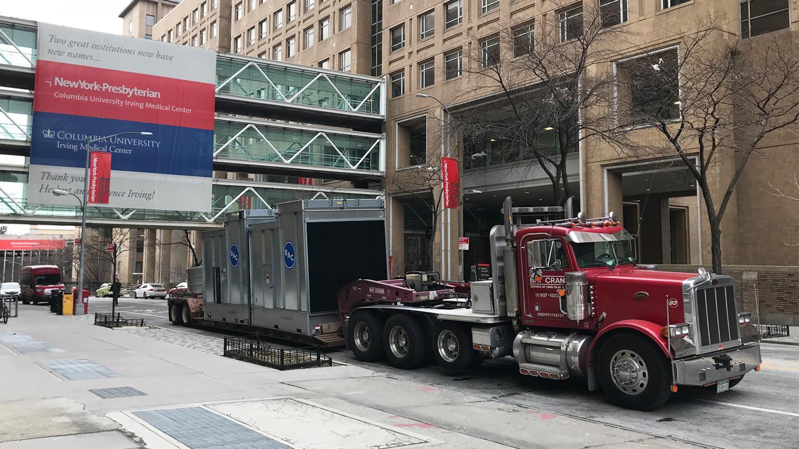 truck delivering cooling towers and passing beneath the walkway over Fort Washington Avenue