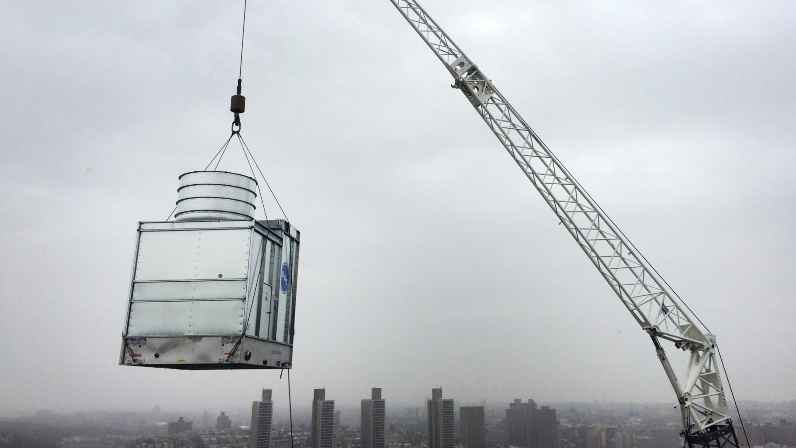 crane delivering equipment to roof of william black building