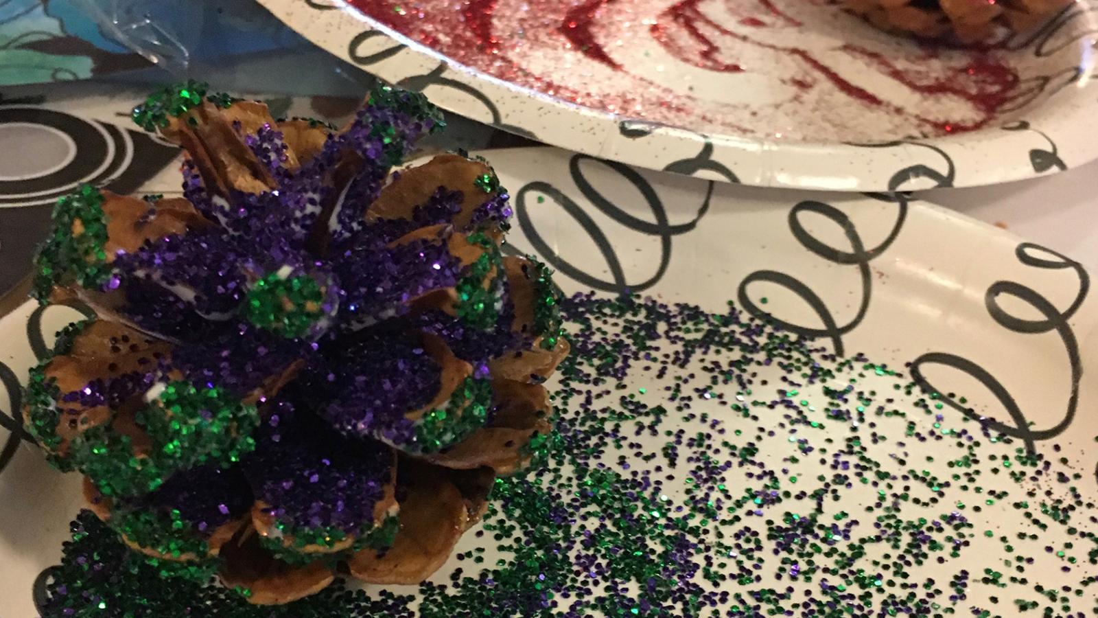Pine cones covered in glitter at an arts and crafts table.