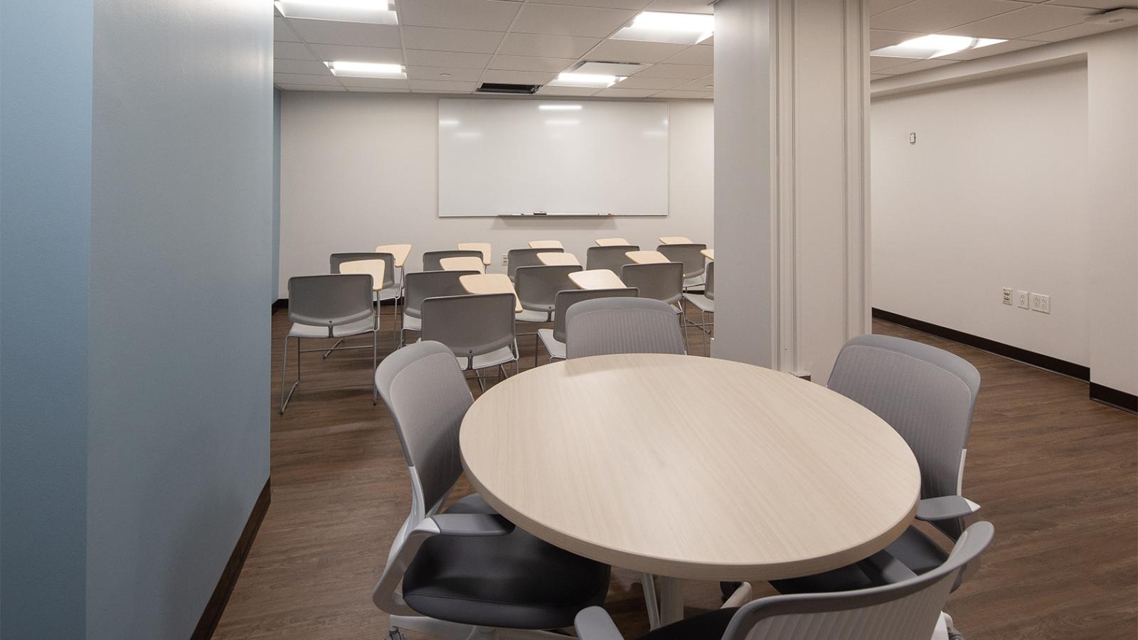 Space divided into classroom and meeting table