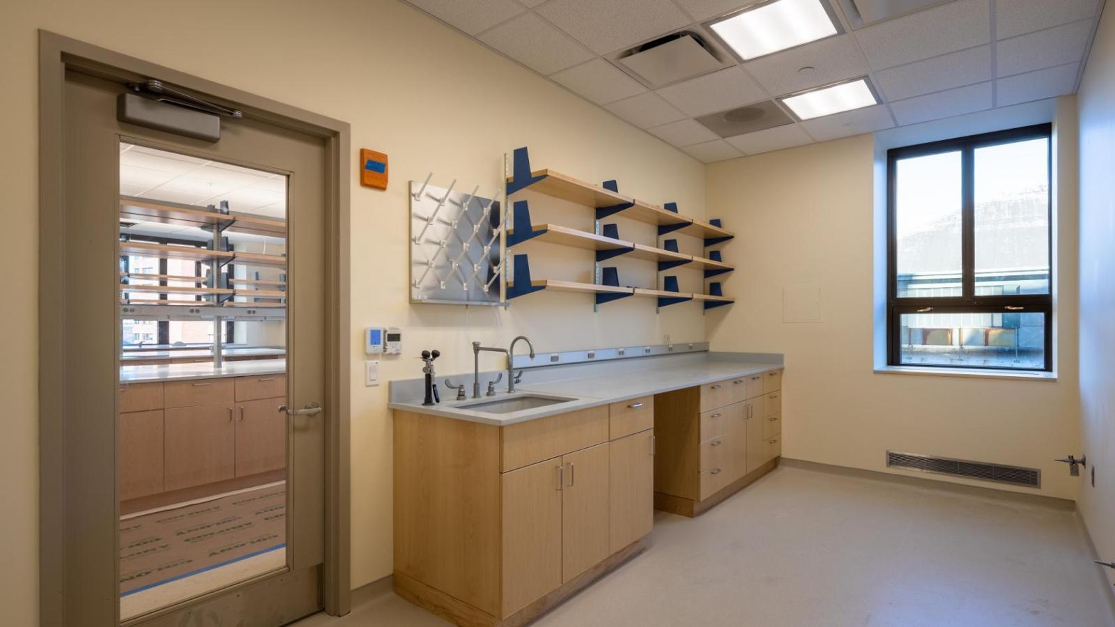 Next to a door to a laboratory is a lab sink