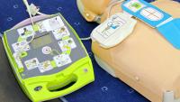 An automated external defibrillator (AED) and dummy