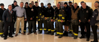 A group of fire fighters from FDNY Battalion 13 stand alongside members of CUIMC and NYP fire safety teams