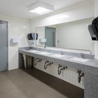 Restroom sink area after renovation with bright lighting and new countertop