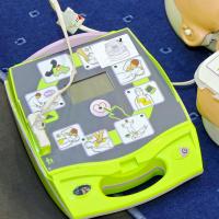 An automated external defibrillator (AED) and dummy