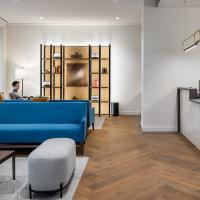 A person sitting in a reception area while a receptionist sits at their desk