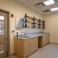 Next to a door to a laboratory is a lab sink