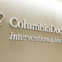 The ColumbiaDoctors Interventional Radiology logo hangs on a beige wall